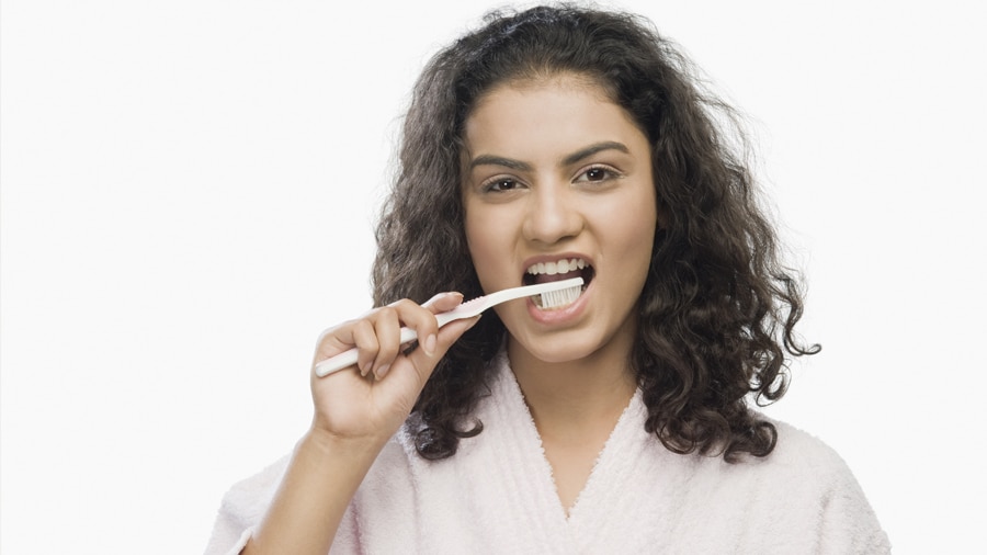 Smiling woman using teeth whitening products
