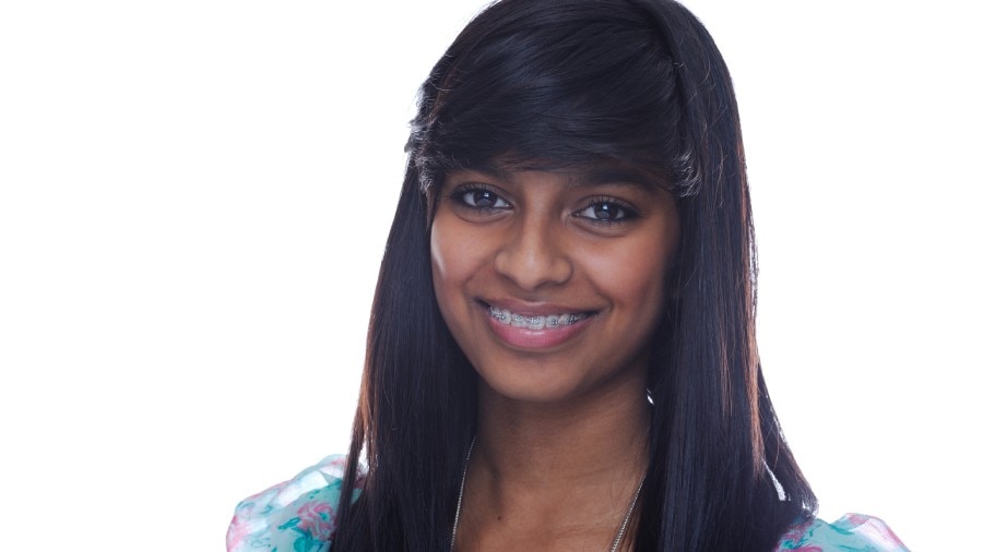 A young lady smiling with tooth braces
