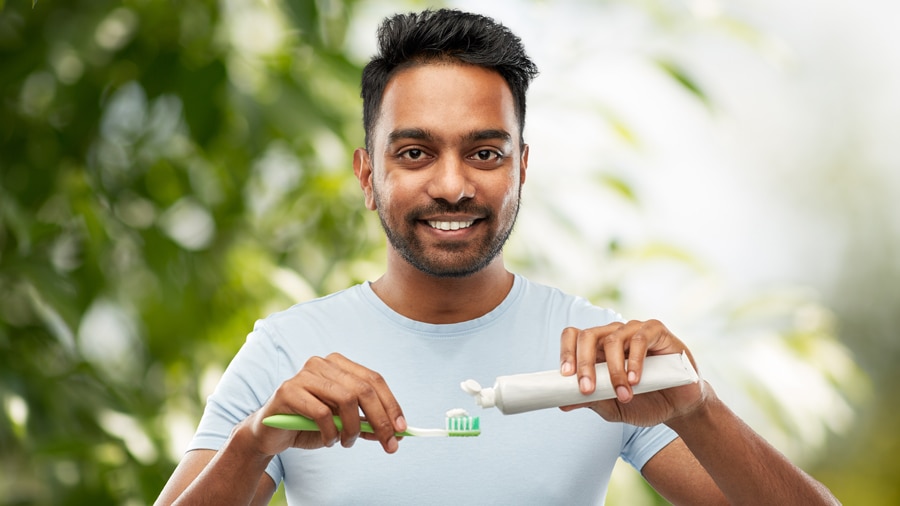 Young man displaying a dazzling smile, endorsing the best whitening toothpaste