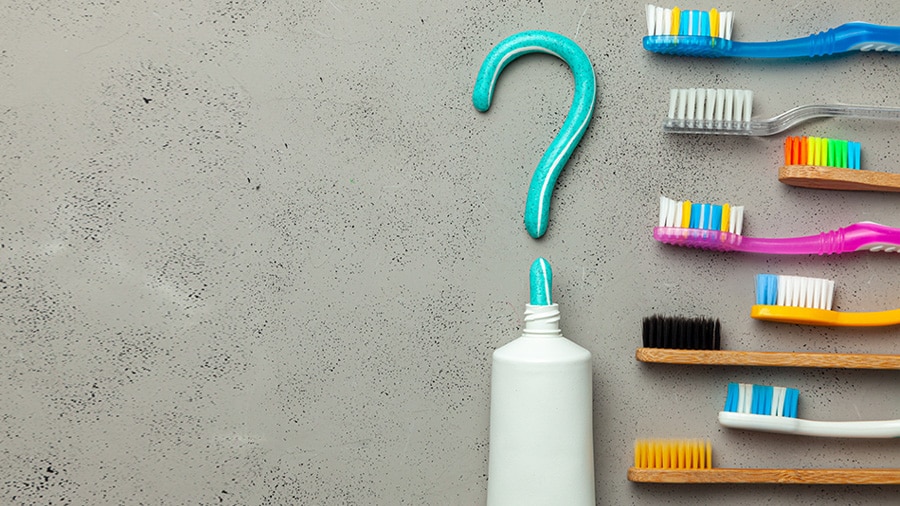 Toothbrushes kept near to toothpaste with a query symbol 