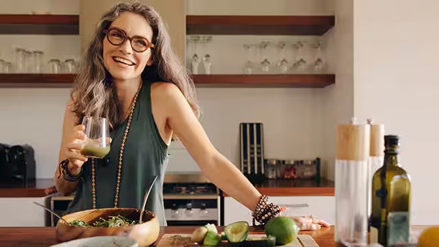 Woman smiling holding a glass