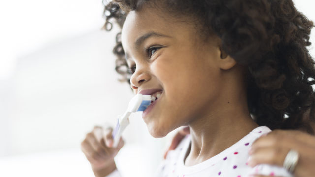 Girl brushing her teeth