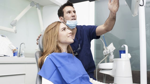 Woman getting tooth decay treatment