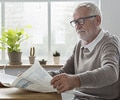 older gentlemen reading a newspaper
