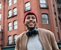 Low angle view of young man standing on city street