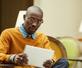 man wearing glasses looking at documents