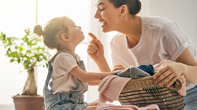 A mom is talking to her child indoors