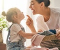 A mom is talking to her child indoors