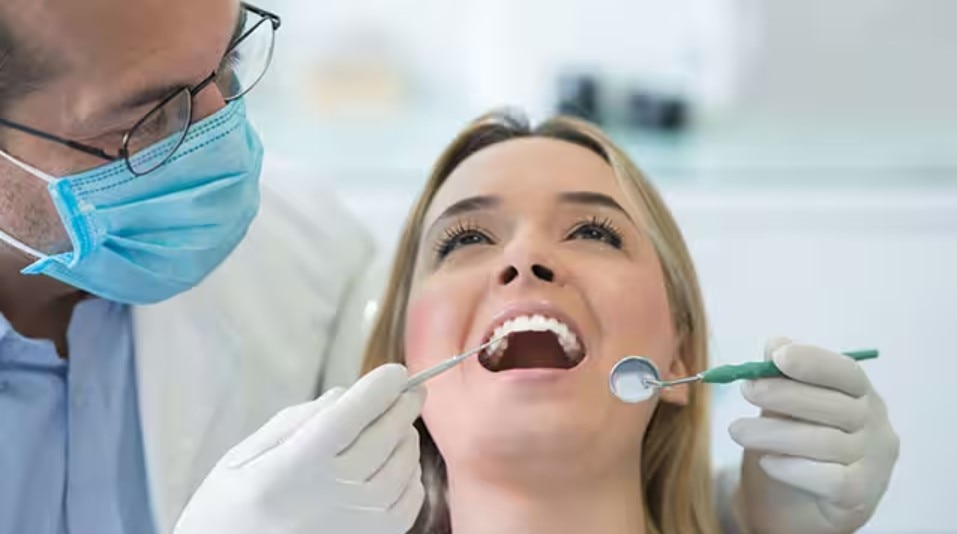 Lady getting a dental checkup for plaque on teeth