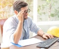 a man with black glasses using the computer