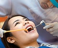 A dentist is treating a female patient