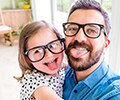 Father and daughter sticking their tongue out