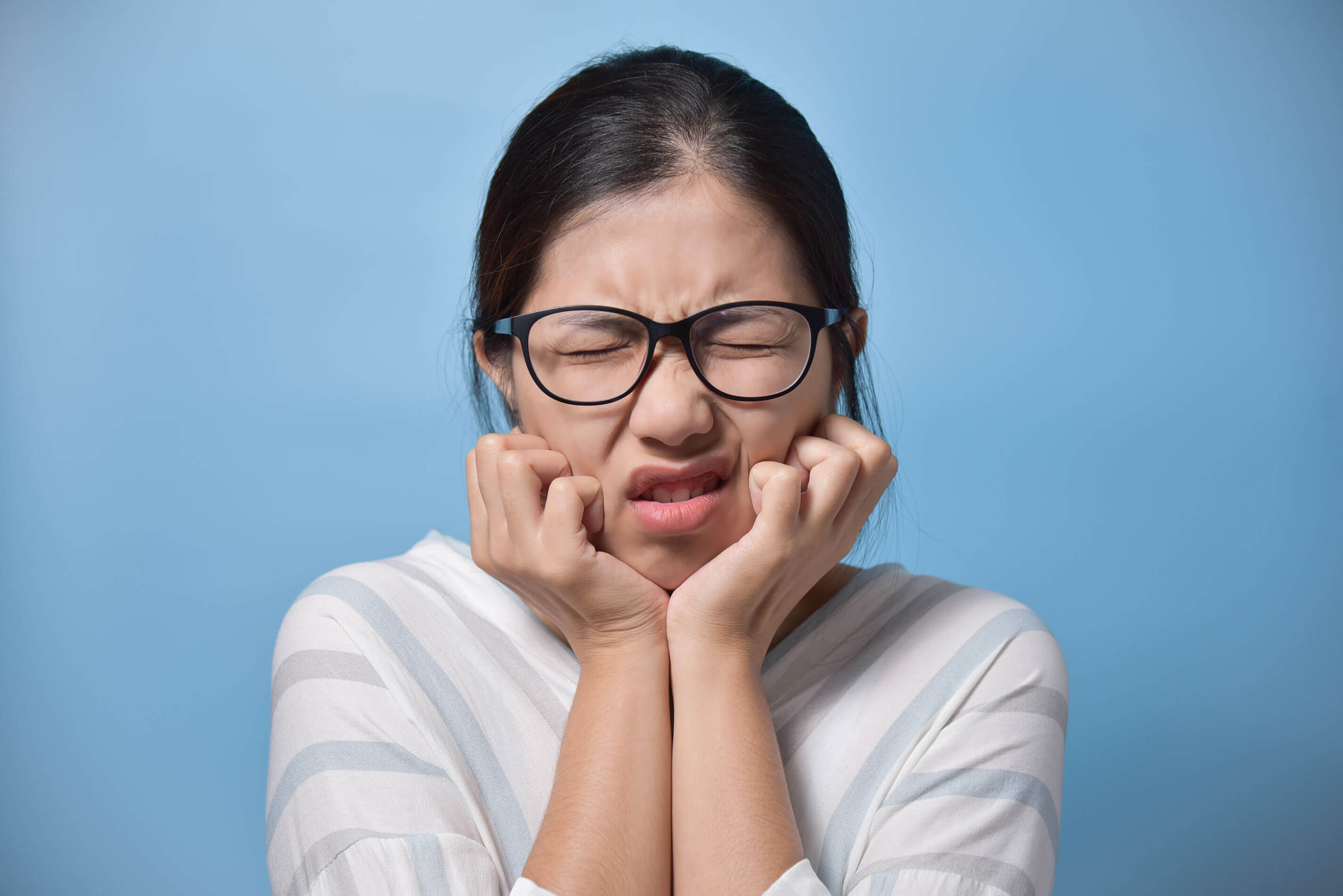 toothache concept frustrated young asian glasses