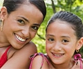 Mother and daughter wearing braces outside