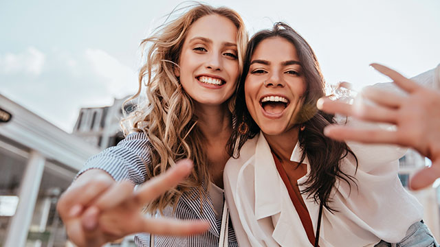 Two young women smiling outdoors