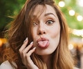A close up of happy young girl sticking her tongue out