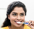 woman brushing her teeth