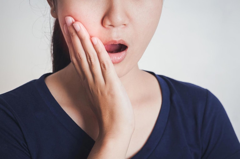 woman-touching-cheek-lip-pain