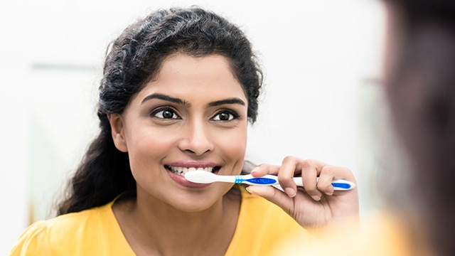 Woman brushing her teeth