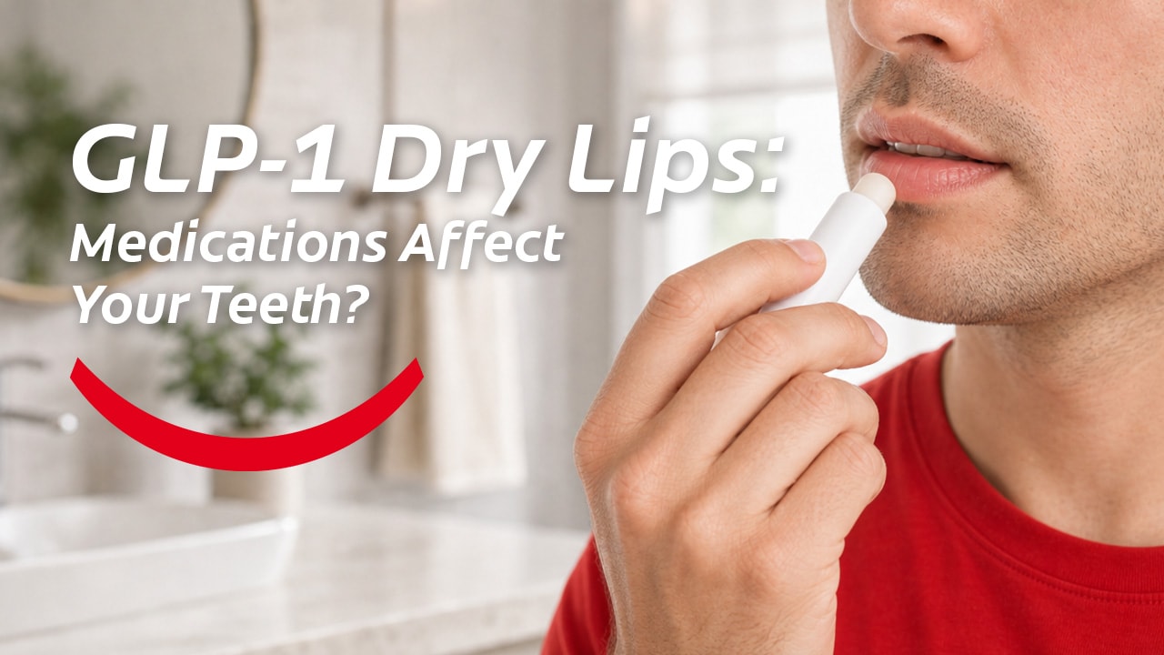A man in a red t-shirt standing in the bathroom and applying lip balm to relieve the symptoms of GLP-1 dry lips. 