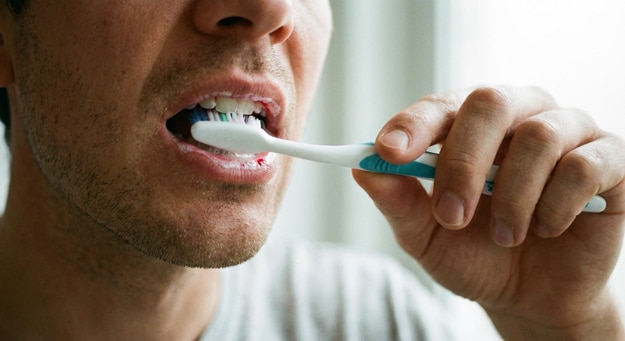 Hombre cepillándose los dientes