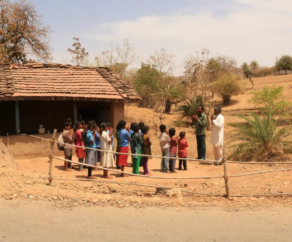 Children & teachers praying on the playground 