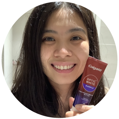 A smiling young girl with Colgate Optic White Purple Toothpaste