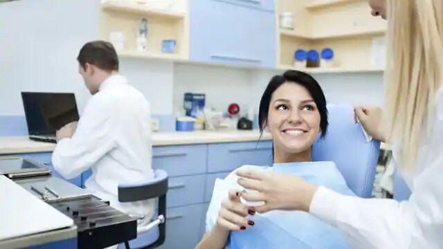 woman at dentist getting filling fixed