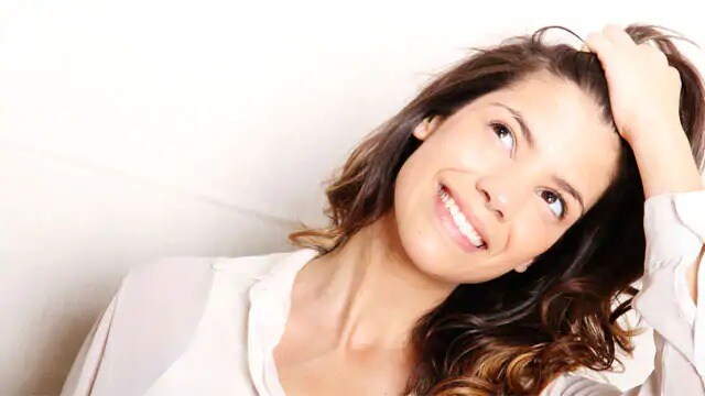 woman smiling after visiting dentist for teeth whitening
