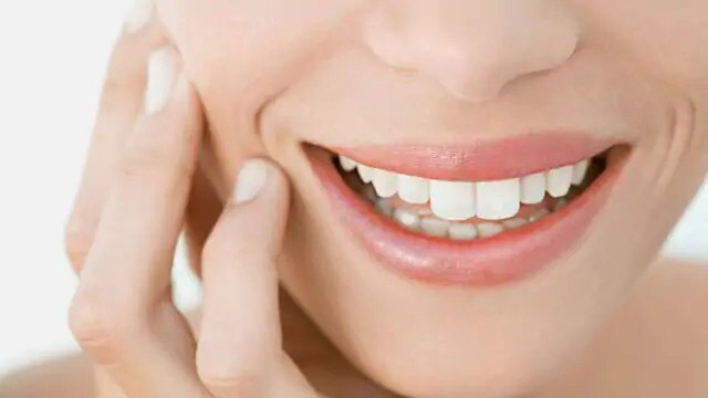 Close-up shot of smile with white teeth; image used for How to Get Rid of Sensitive Teeth After Whitening article