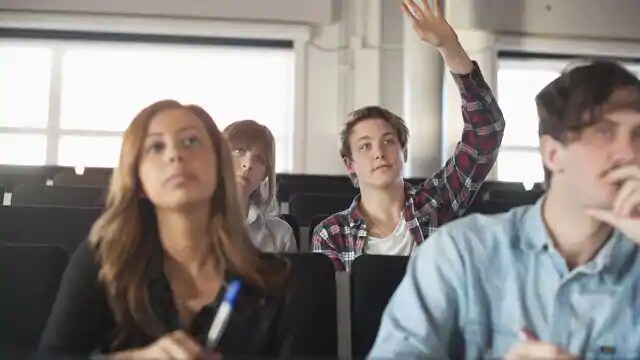 dental student raising hand to discuss gum disease