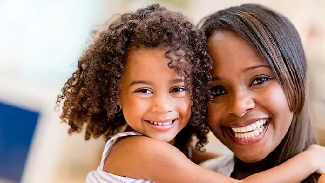 mom and daughter smiling together