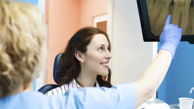 woman in dentist office after wisdom tooth removal