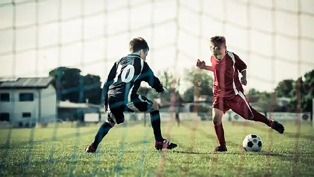 kids playing in a soccer game