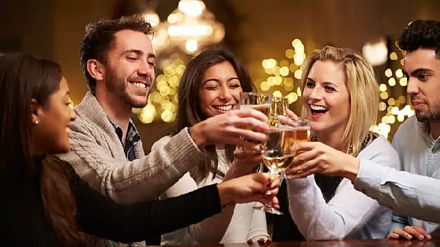 A group of people smiling during a champagne toast