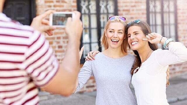 women smiling with whitened teeth for picture