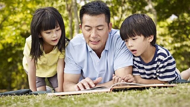 father teaching kids about teeth