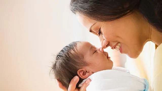 mother holding newborn baby