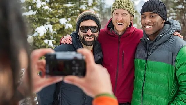 friends taking a picture together while skiing