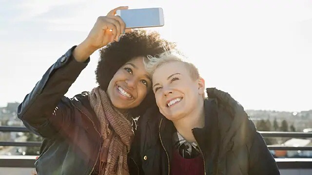 women smiling after using teeth whitening light