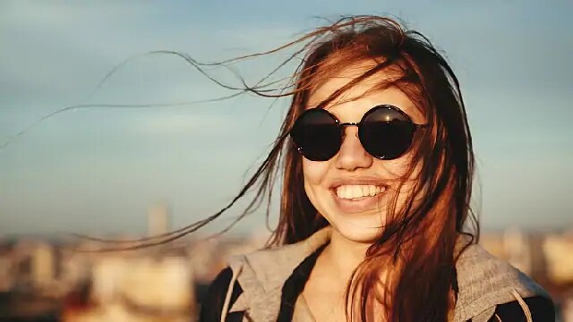 woman smiling after teeth whitening procedure