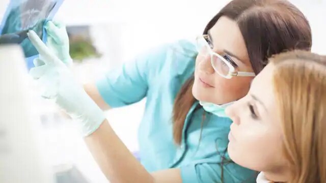 dentist explaining dental exam to patient