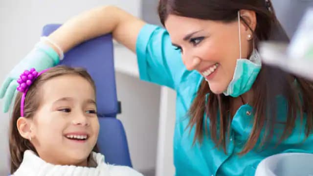 child smiling during dental exam