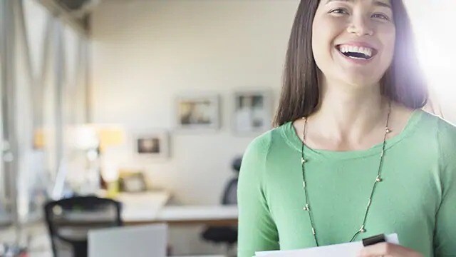 woman smiling after laser teeth whitening procedure