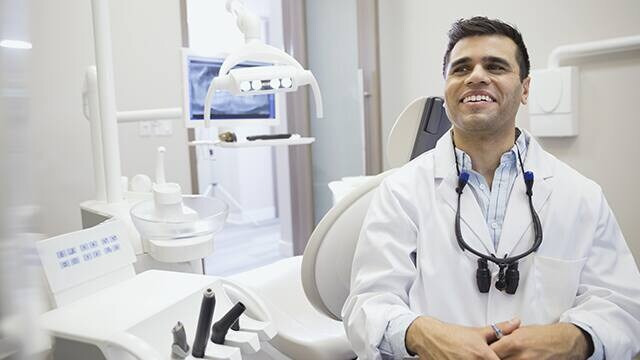 dental hygienist comforting patient after dental exam