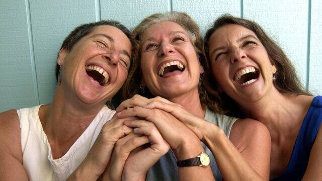 women with newly whitened teeth smiling