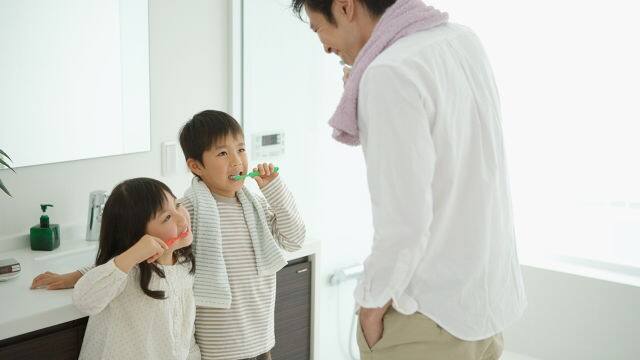 family brushing teeth together
