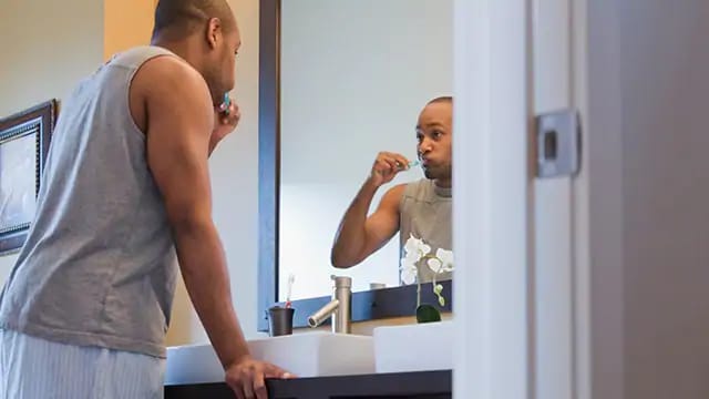 man brushing to keep healthy gums and teeth