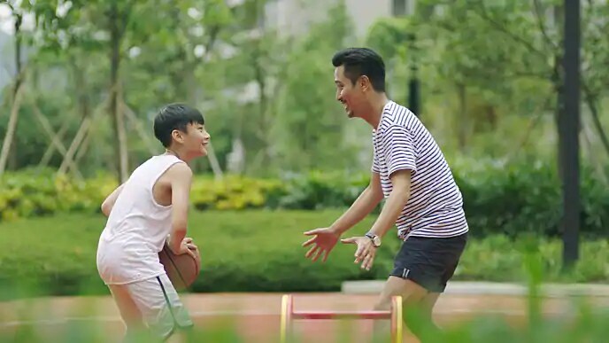 father and son playing basketball