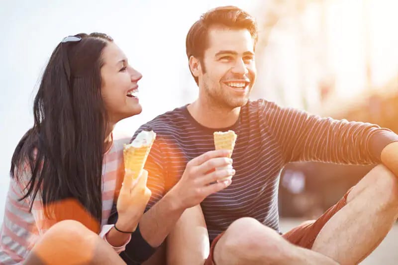 a couple smiling while eating ice cream